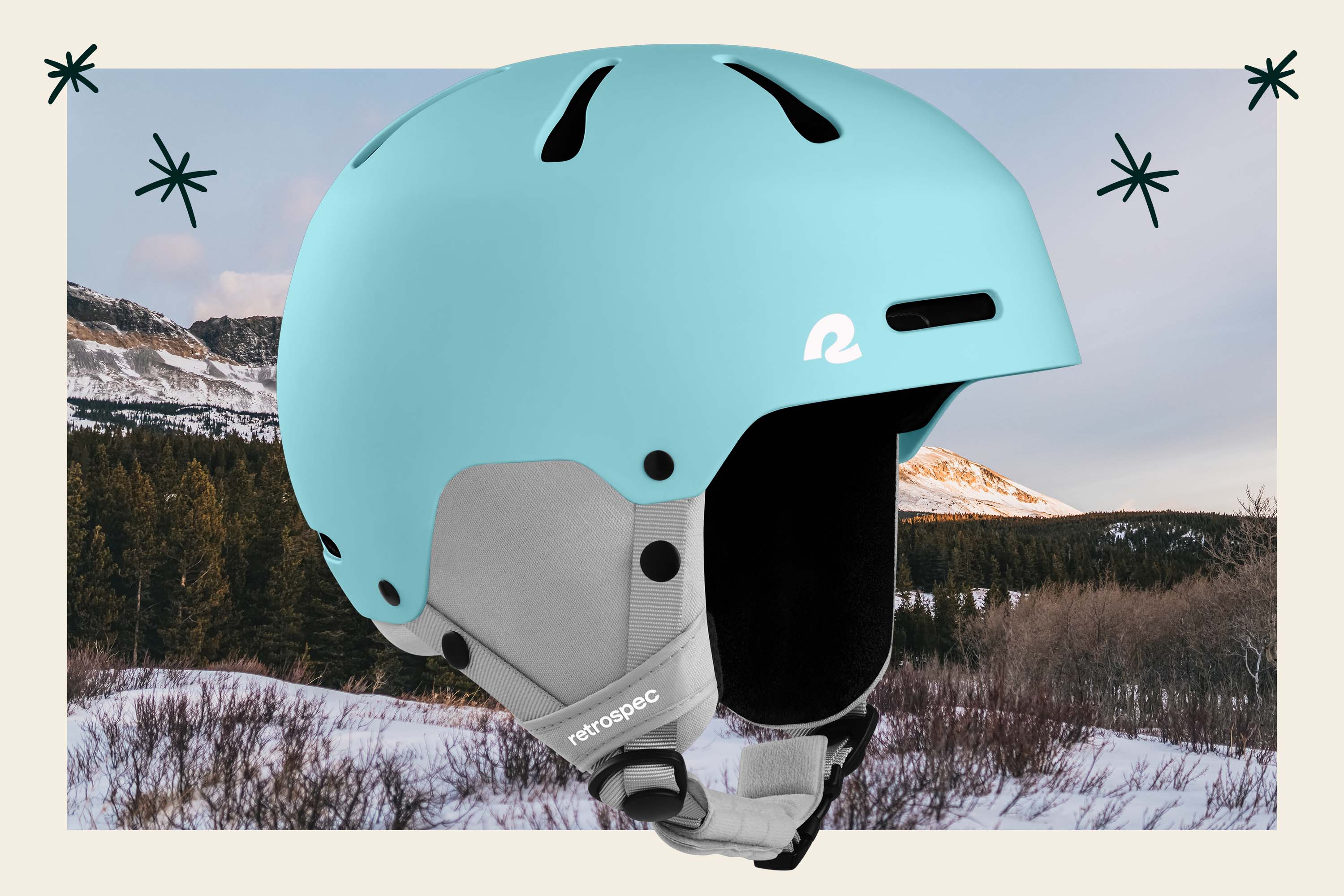 Light blue ski and snowboard helmet in front of a snowy mountain scene.