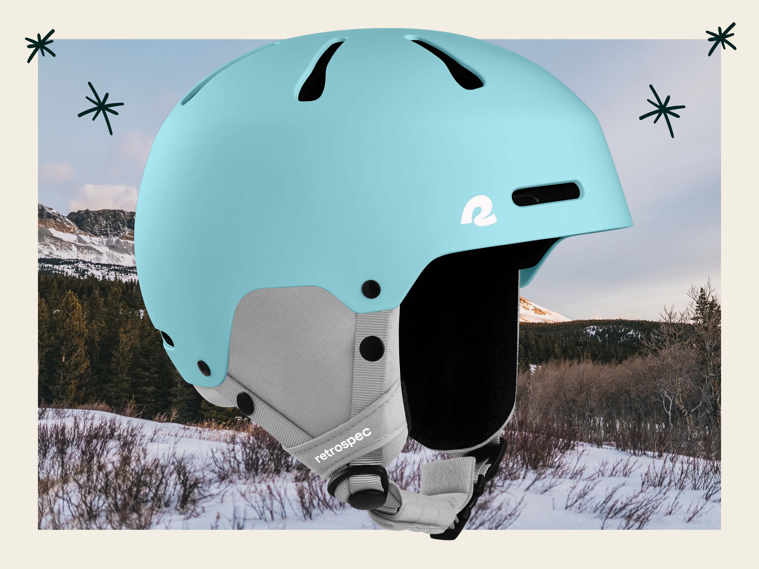 Light blue ski and snowboard helmet in front of a snowy mountain scene.